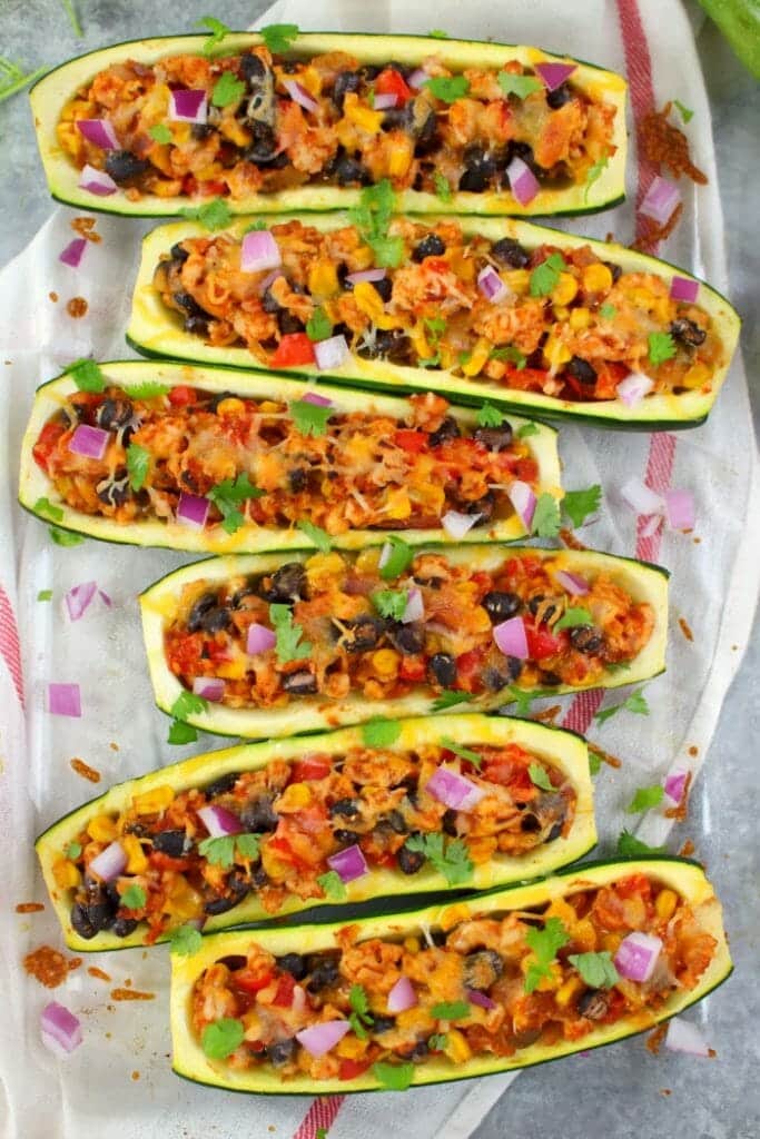 Looking for a healthy, low-carb dinner idea that actually tastes good? These Taco Stuffed Zucchini Boats are made with lean ground turkey filling along with peppers, onions, beans and corn. Loaded with flavor, these stuffed zucchini are the perfect healthy dinner!