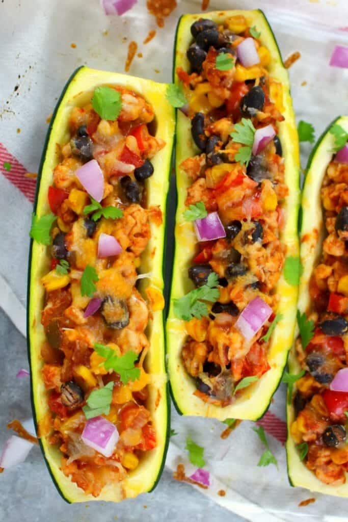 Looking for a healthy, low-carb dinner idea that actually tastes good? These Taco Stuffed Zucchini Boats are made with lean ground turkey filling along with peppers, onions, beans and corn. Loaded with flavor, these stuffed zucchini are the perfect healthy dinner!