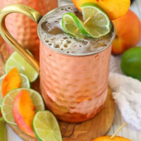 A delicious twist on the classic Moscow Mule recipe! Made with just a few simple ingredients, this Ginger Peach Moscow Mule combines the cold, crisp flavors of ginger beer with fresh peaches. Cheers!