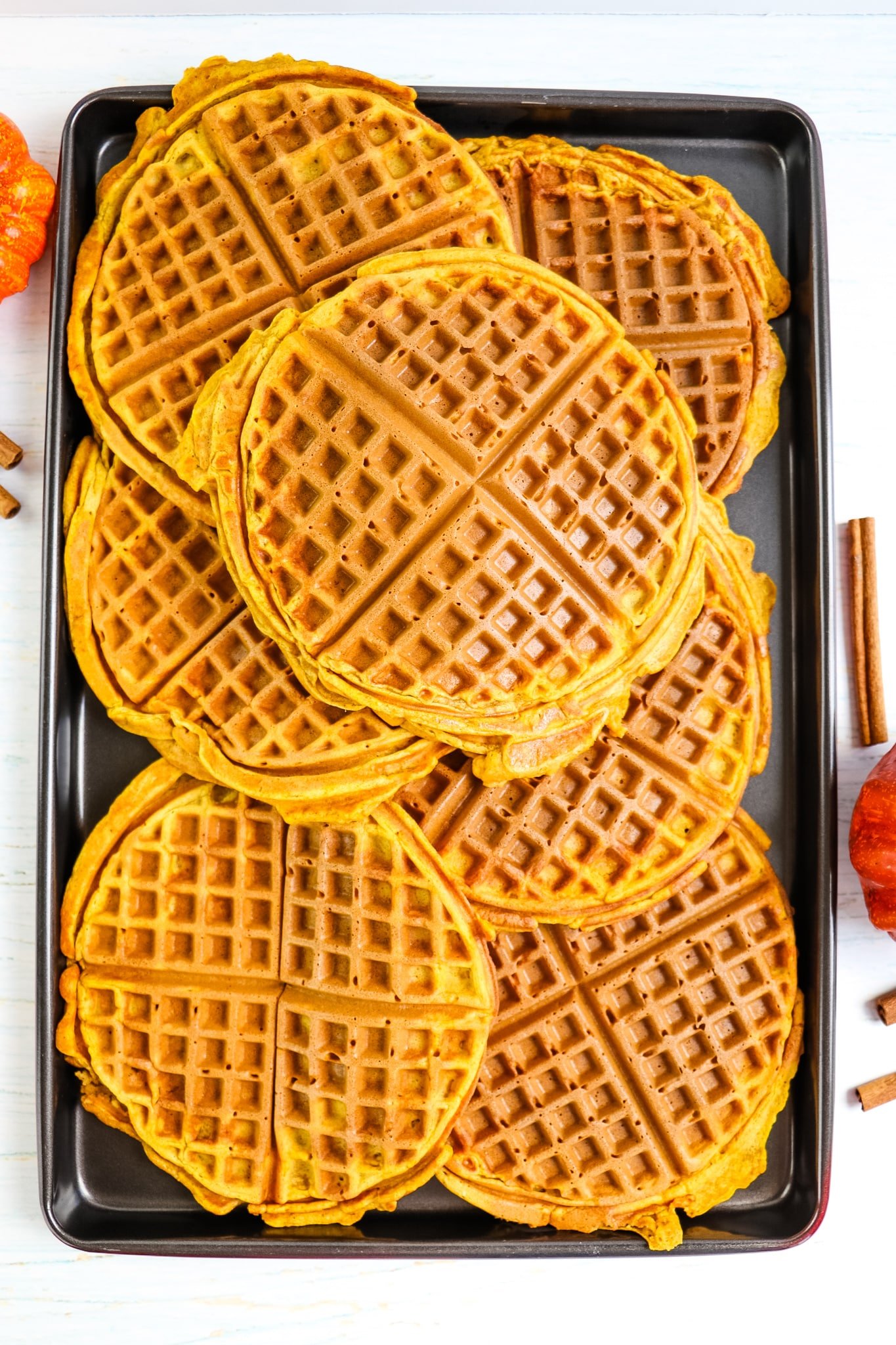 Pan of round pumpkin spice waffles.