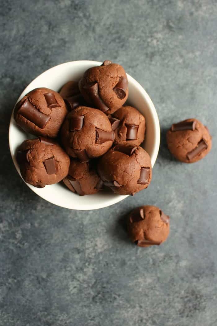 double chocolate protein balls in a white bowl.