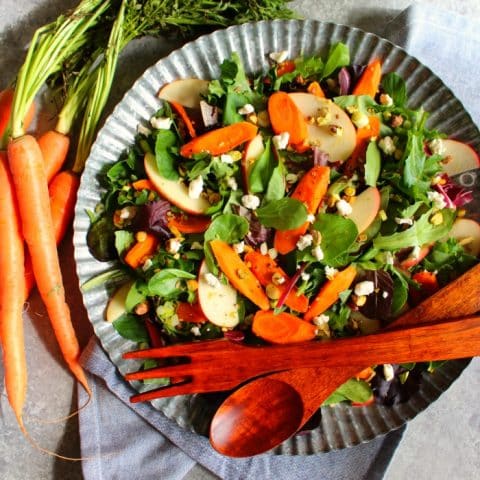 This Roasted Carrot Salad has wonderful flavors that come together with crisp apples and savory pistachios making the most amazing salad! Easy enough for a weeknight dinner, and beautiful enough to serve for a holiday dinner.