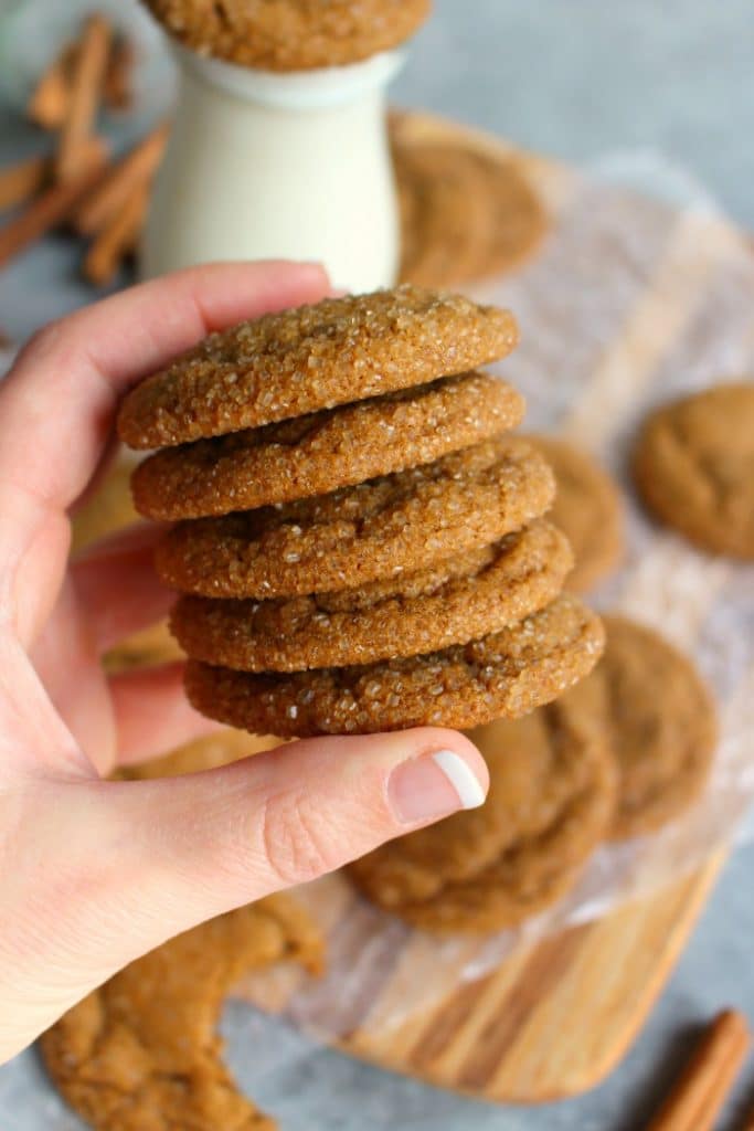 Stack of five ginger molasses cookies held in hand.