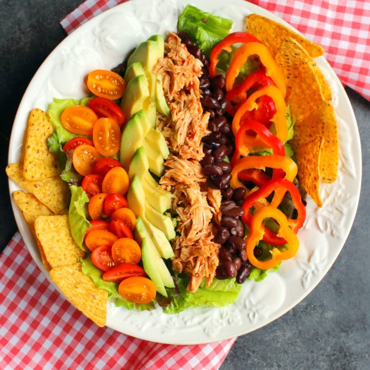 This simple Chicken Taco Salad recipe is the perfect healthy lunch for packing and taking to work! Loaded with savory shredded chicken, black beans and veggies, this taco salad will be your new favorite way to pack your lunch!