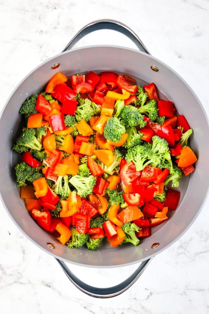 Broccoli and bell peppers in a large skillet for steaming.