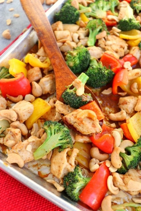 This Healthy Cashew Chicken recipe will be your new favorite weeknight dinner idea. Simply made, this sheet pan dinner idea is loaded with veggies and an amazing sauce.