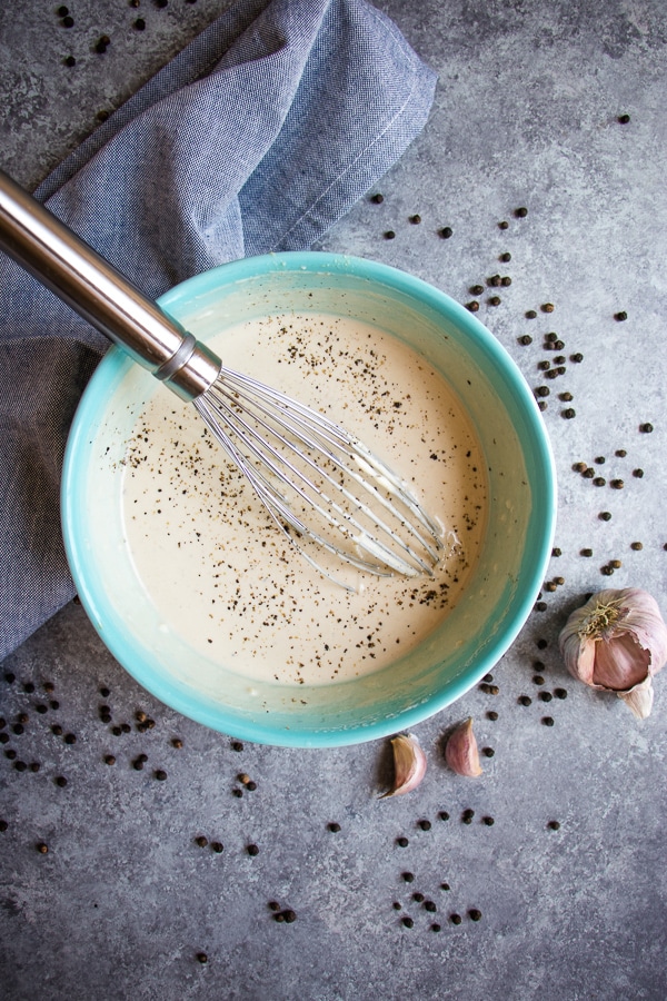 Forget the bottled stuff - this Healthy Caesar Dressing is way better than anything you buy off the shelf. This Greek yogurt dressing recipe is simple to make, tastes incredible and comes together in just minutes! Definitely the BEST Homemade Caesar Dressing around!