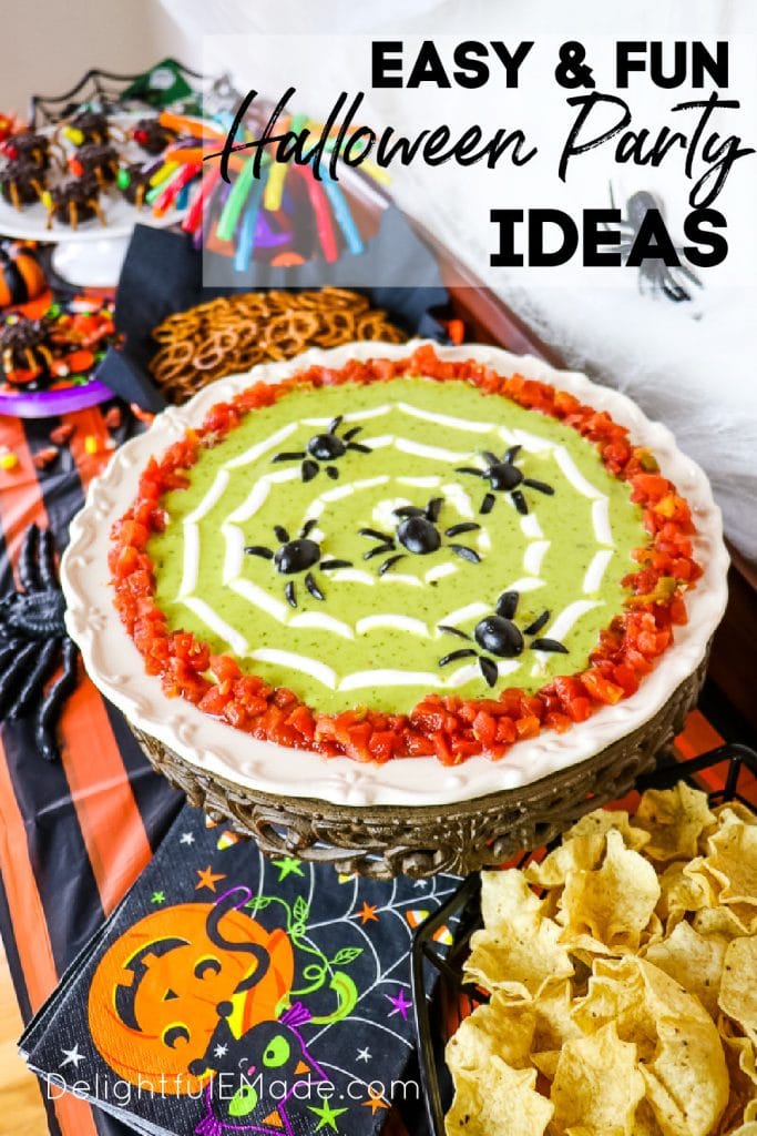 Halloween party buffet, with platter of bean dip with olive spiders as garnish.