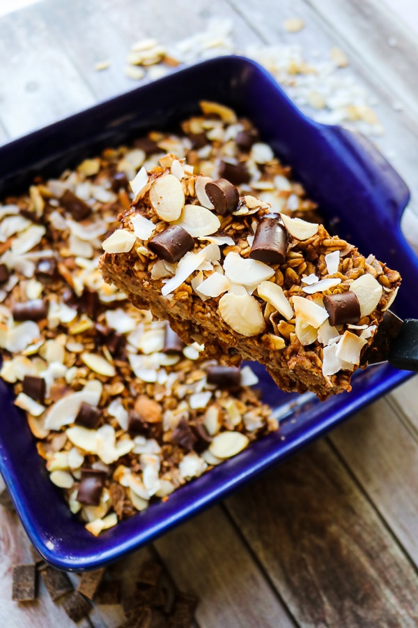 These healthy oatmeal bars will be your new favorite way to do breakfast! Made with coconut, almonds and a hint of chocolate, these baked oatmeal bars have all the flavors of the classic almond joy! With no refined sugar, flour or oil, these oatmeal breakfast bars are a great make-ahead  breakfast!