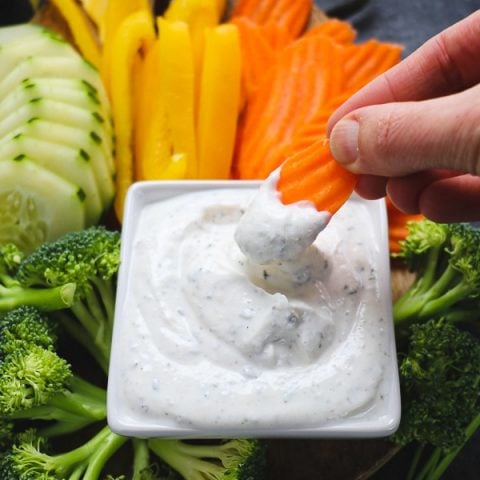 Need a healthy snack option? This simple, 5-ingredient Greek Yogurt Veggie Dip is the perfect way to enjoy fresh veggies. Enjoy with veggies, spread on a sandwich or topping a salad, this Greek Yogurt Ranch Dip is a great alternative to a dip mix!