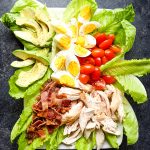 This healthy chicken cobb salad recipe is nothing short of incredible! With traditional cobb salad ingredients, this healthy version leaves out unhealthy oils and over-sugared dressings, but keeps all of the delicious flavors. I'll show you how to make cobb salad for meal prep, too!