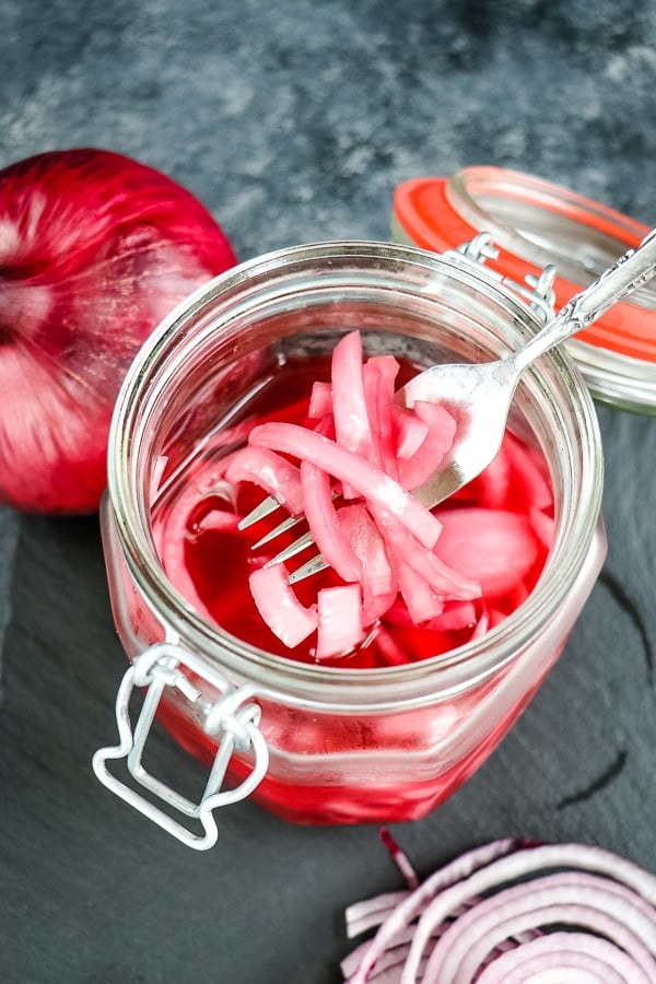 Wondering how to make pickled red onions? No canning or pressure cookers are needed with this quick pickled red onions recipe! Just a few simple ingredients and you'll get the most flavorful, crisp pickled red onions for topping salads, sandwiches, wraps and more!