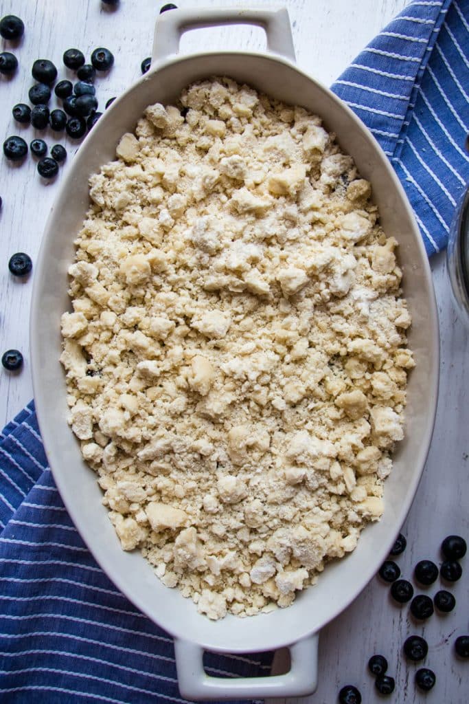 Cake mix crubles added to the blueberries and ready to be baked in the oven.