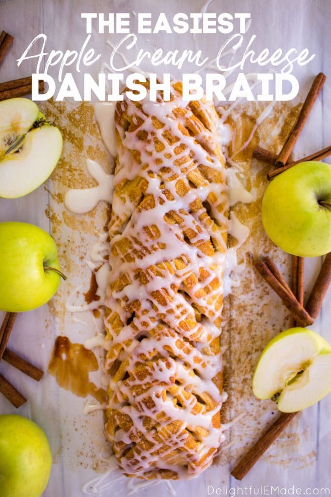 Apple Danish Braid with glaze drizzled on top and garnished with golden delicious apples and cinnamon sticks.