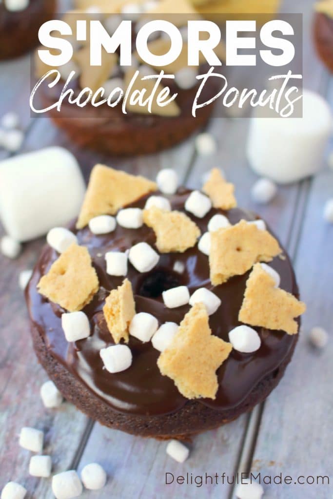 Chocolate S'mores Donuts, garnished with mini marshmallows and graham cracker pieces.