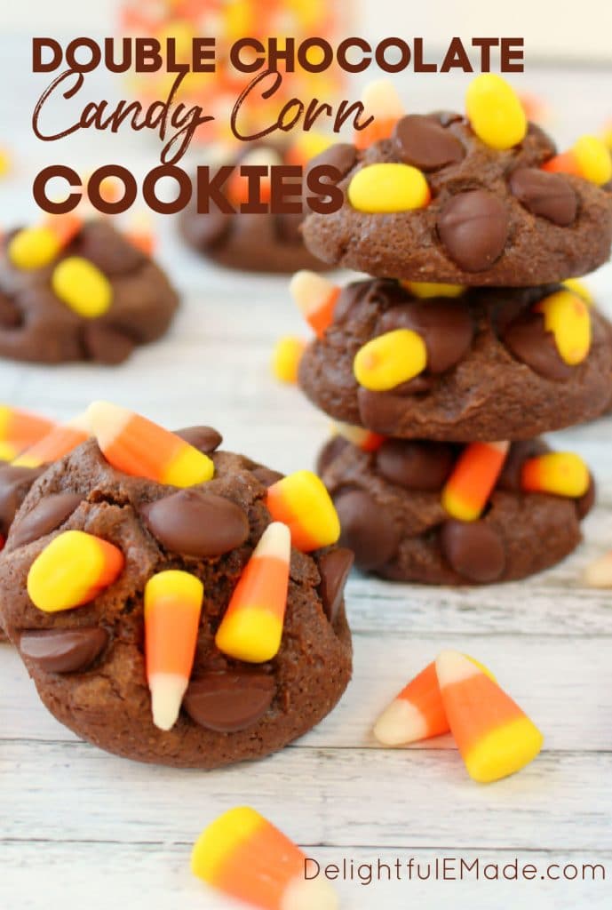Double Chocolate Candy corn cookies - stacked and garnished with candy corn on white surface.