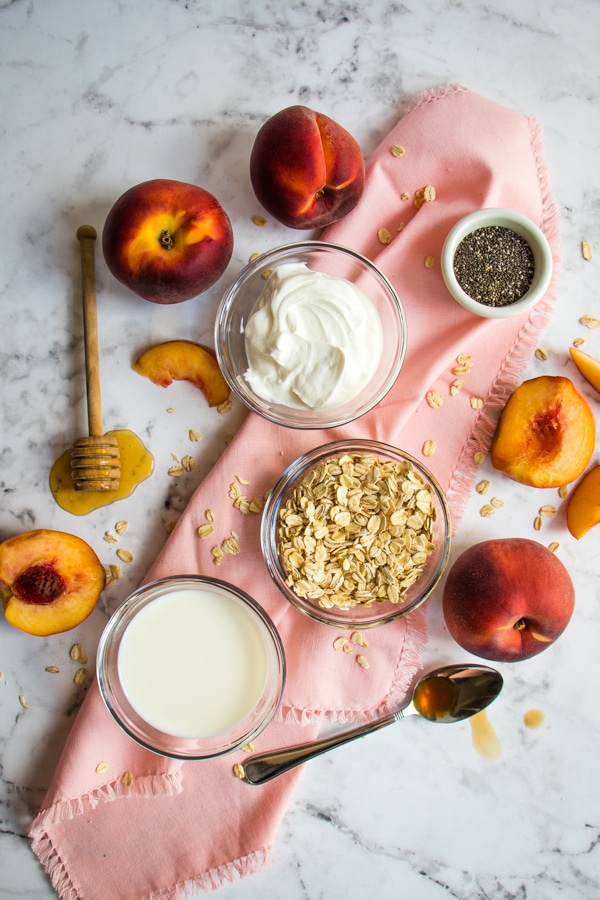 Ingredients for peach overnight oats; oats, milk, yogurt, vanilla, honey, chia seeds.