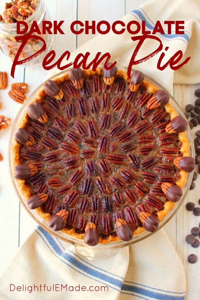 Dark chocolate pecan pie recipe in pie plate garnished with chocolate chips and pecans.