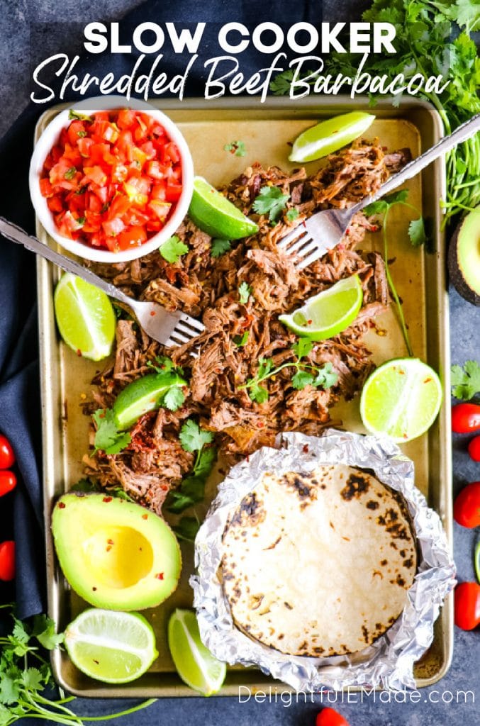 Sheet pan of slow cooker mexican shredded beef barbacoa with toppings.