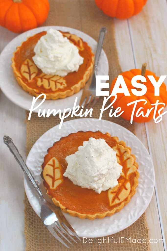 Pumpkin tarts on plate topped with whipped cream