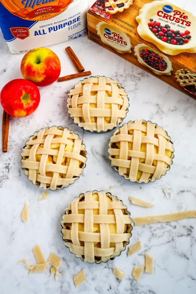 Apple pie tarts topped with a lattice crust.