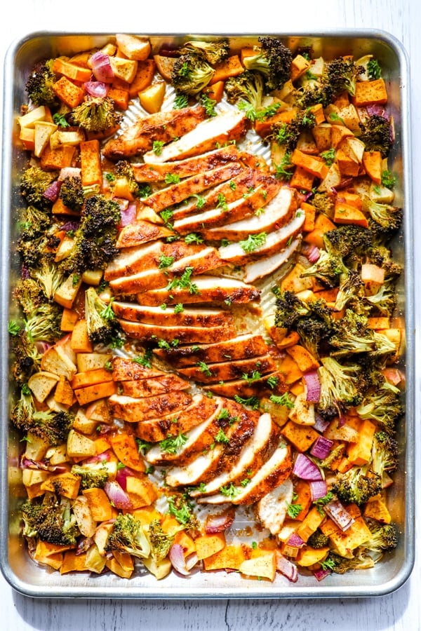 Baked sheet pan chicken and sweet potatoes, chicken sweet potato broccoli on sheet pan.