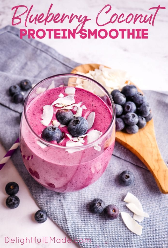 Healthy blueberry smoothie, blueberry protein smoothie in a glass topped with blueberries and coconut.