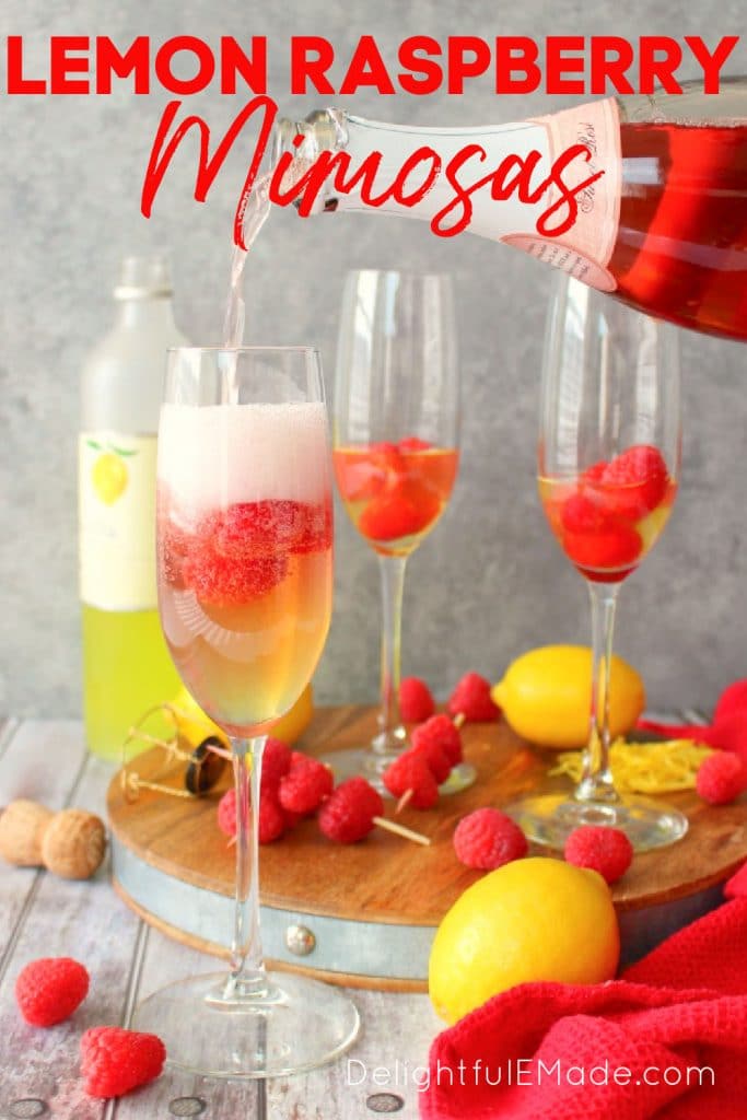 Lemon raspberry mimosa being topped off with rose champagne, raspberries in glasses.