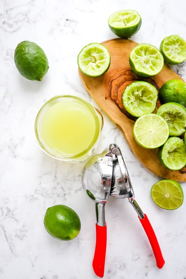 Limes and lime juice for coconut margarita recipe.