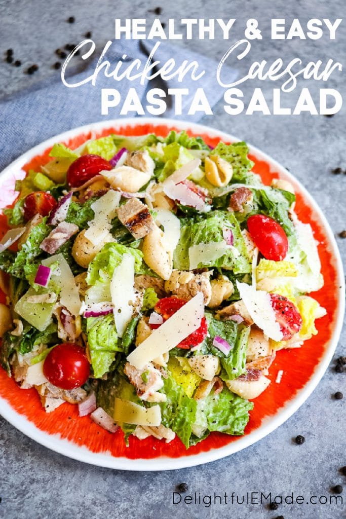 Chicken caesar pasta salad, on a plate with tomatoes.