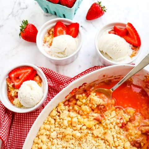Strawberry dump cake recipe with vanilla ice cream. Strawberry cobbler with cake mix in baking dish.