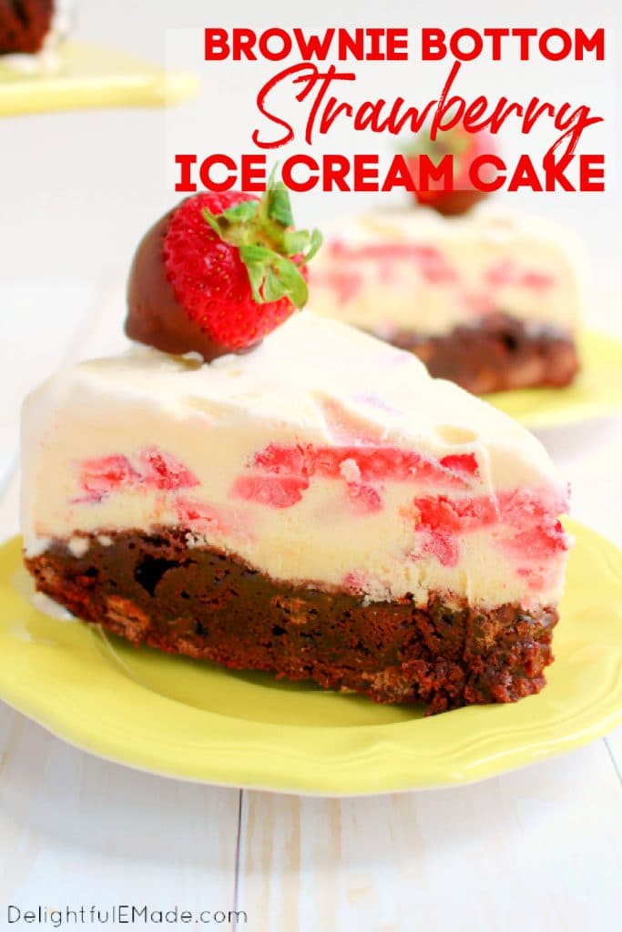 Slice of strawberry ice cream cake with brownie bottom on plate, topped with chocolate covered strawberry.