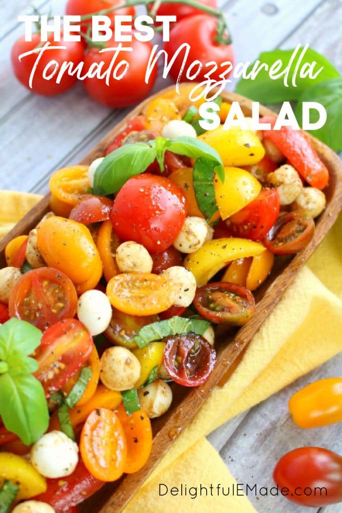 Caprese tomato salad with cherry tomatoes, italian tomato salad in bowl with basil leaves.