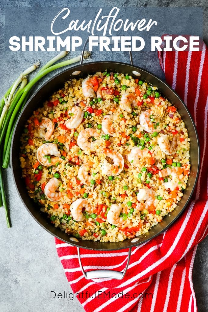 Large skillet with cauliflower shrimp fried rice, garnished with green onions.
