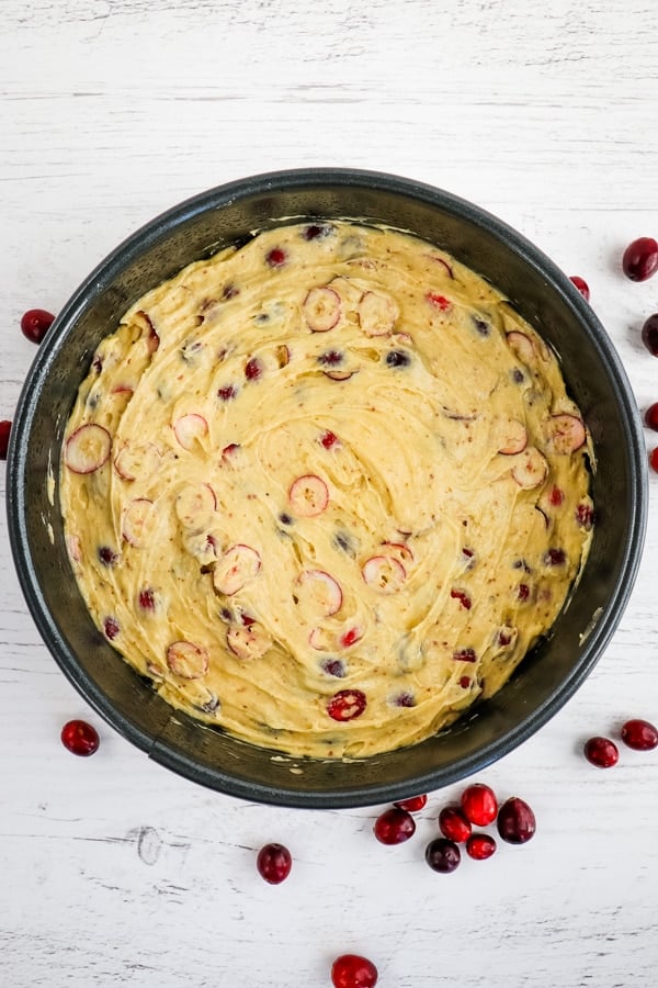 Cranberry coffee cake batter spread into pan.