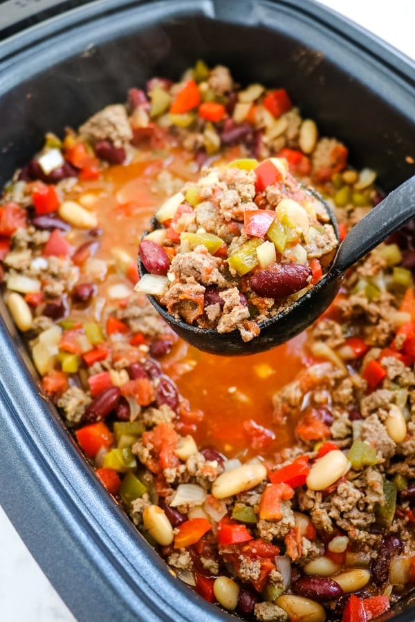 crock pot chili with ladle of chili over crock pot.