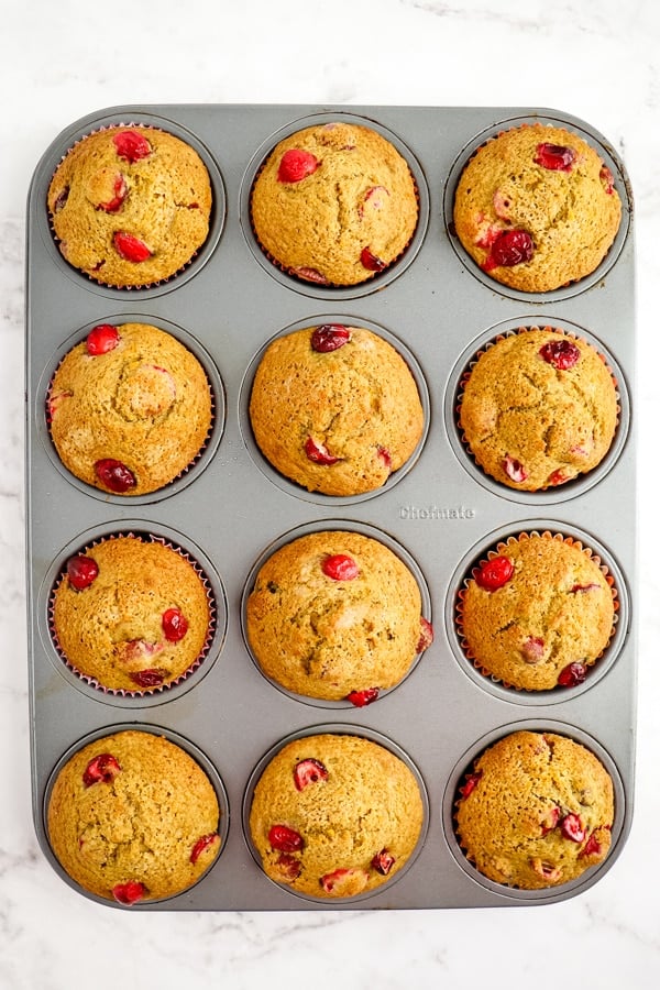 Baked cranberry orange muffins, in muffin pan.