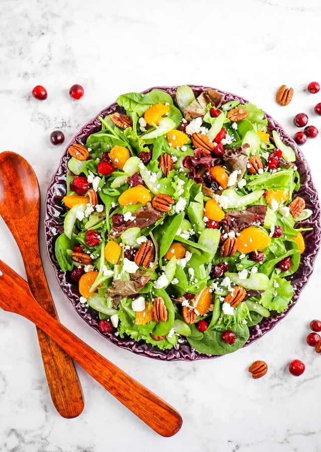 Cranberry salad recipe on platter with utensils on the side.