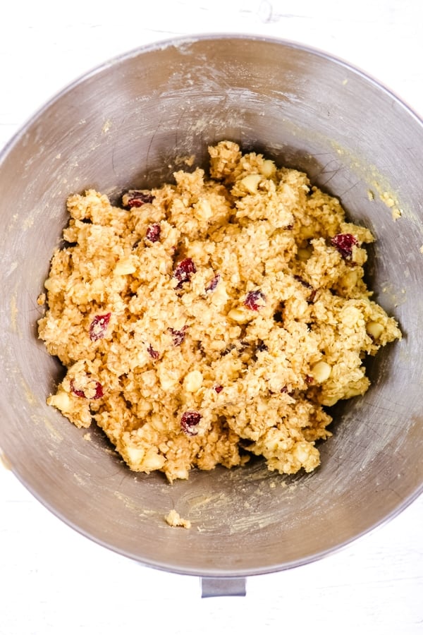 White chocolate chunk cranberry oatmeal cookie dough in mixing bowl.