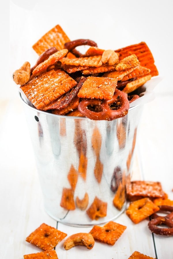 Snack mix with pretzels, cashews and cheez-its in mini bucket.