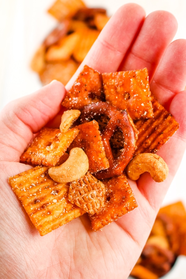Snack mix in hand.