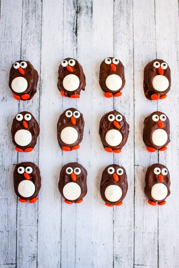 Completed penguin cookies on white board surface.