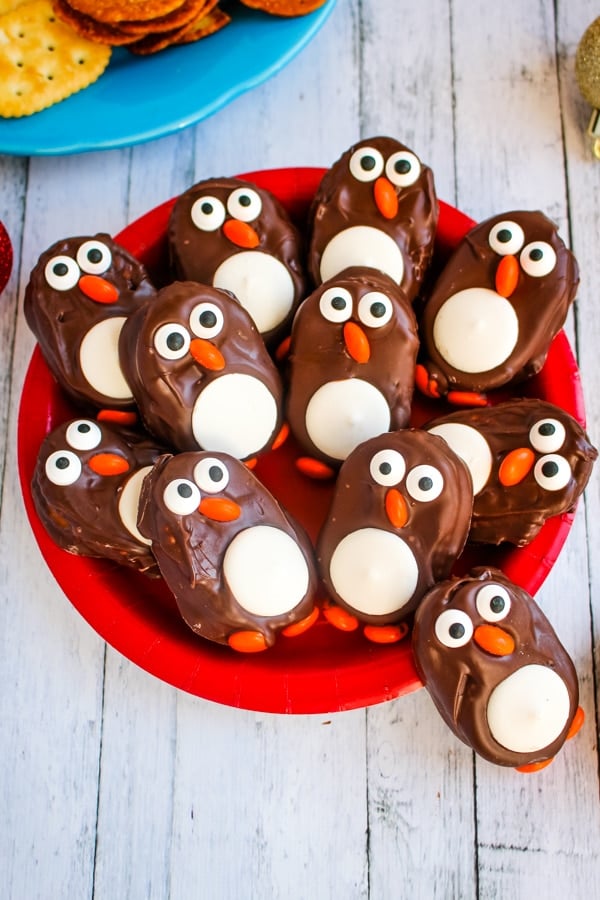 No bake penguin cookies on red plate.