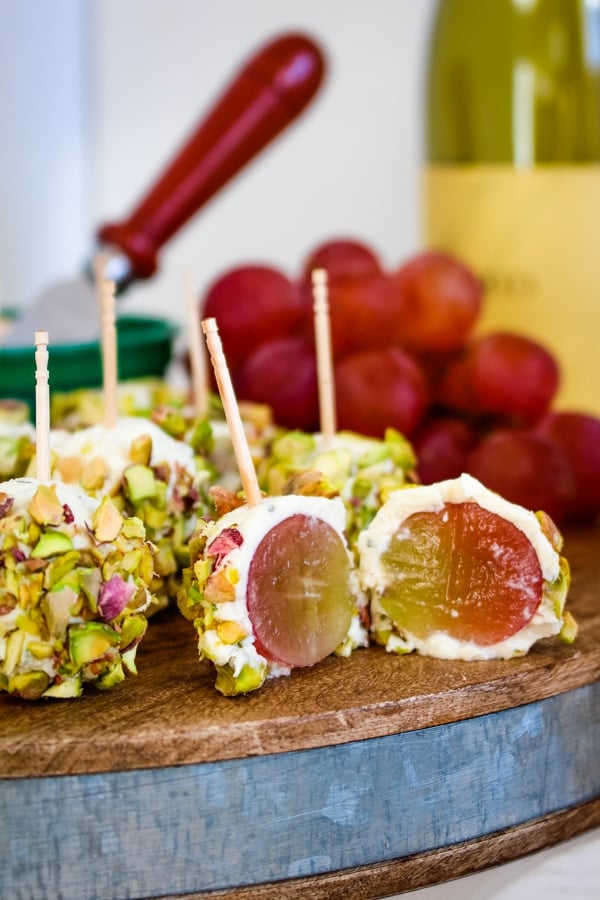 Pistachio grape cheese appetizer, sliced in half to see grape inside.