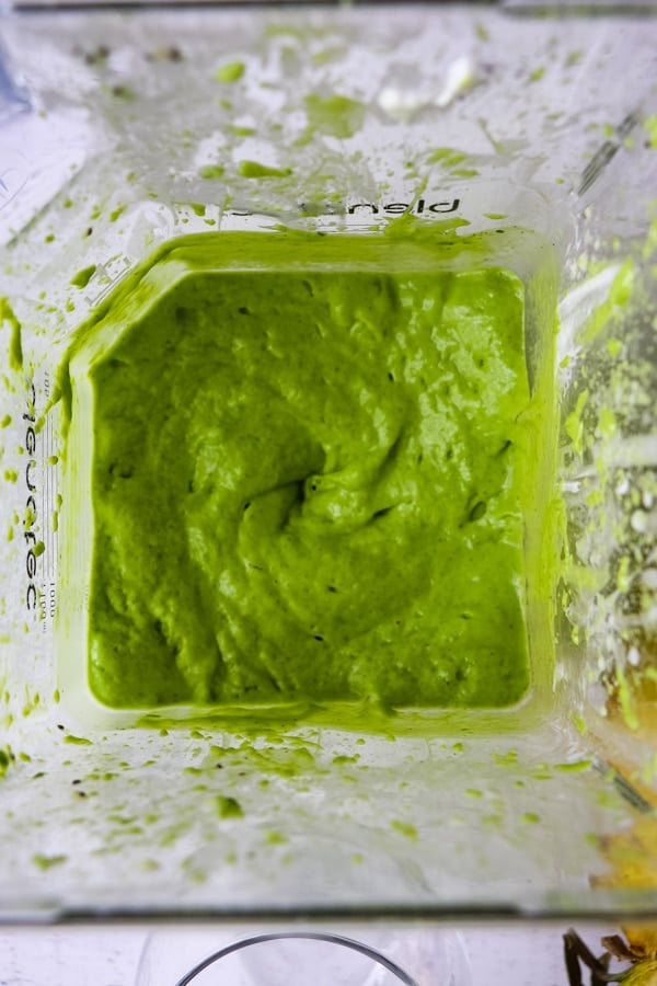 Green smoothie just blended in bottom of blender.