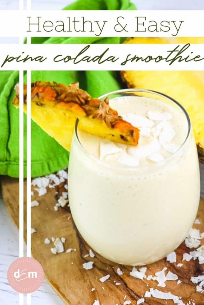 Pina colada smoothie in a clear glass, garnished with pineapple slice and coconut flakes.