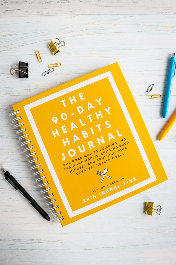 The 90-Day Healthy Habits Journal with pens and clips on the side.