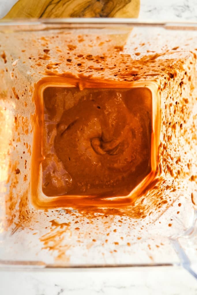 Blended ingredients of chocolate smoothie in blender, looking down into blender jar.