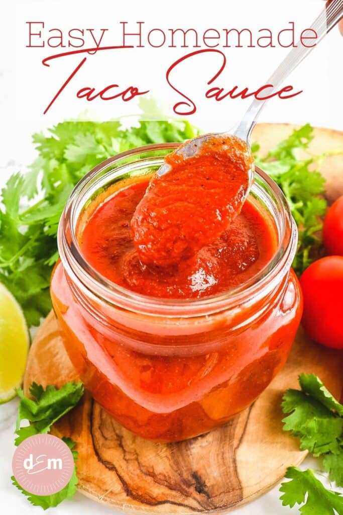 Homemade taco sauce in a jar, with spoon coming out of sauce.