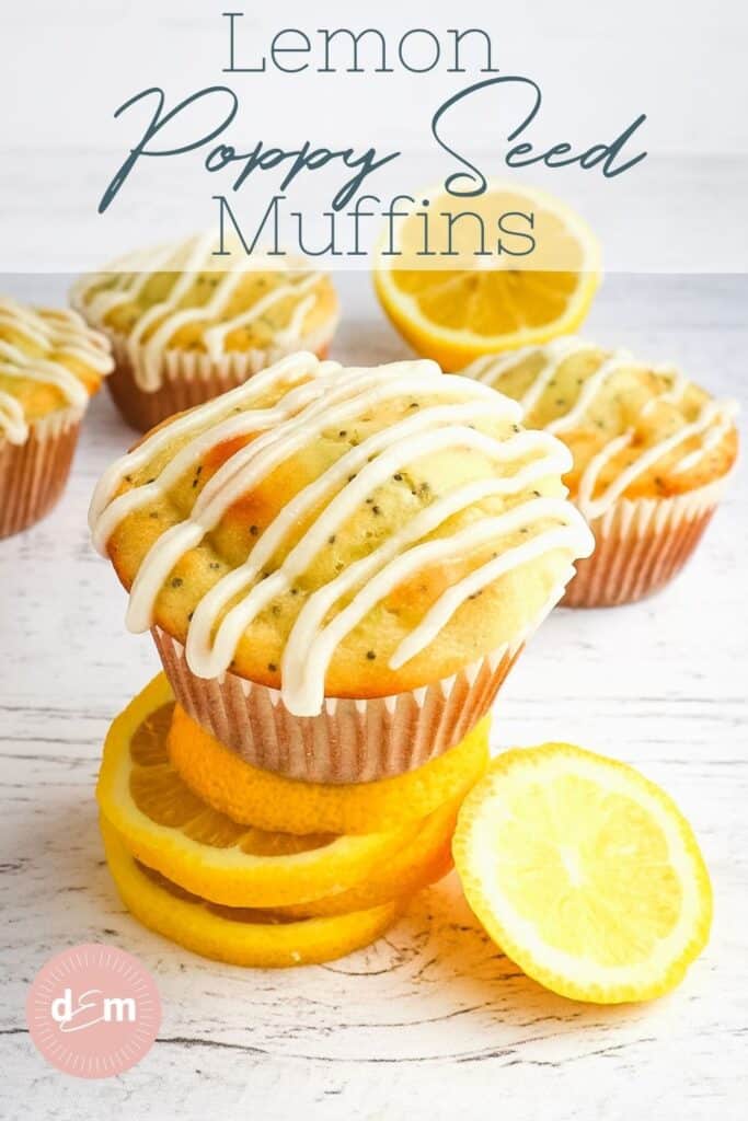 Frosted lemon poppy seed muffin on top of stack of lemon slices.